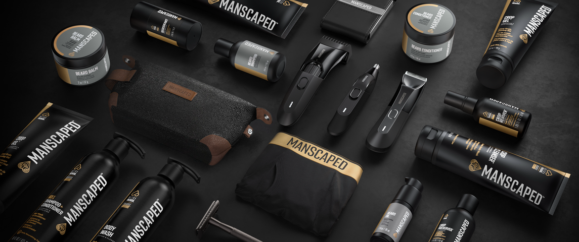 Collection of Manscaped grooming products on a dark surface